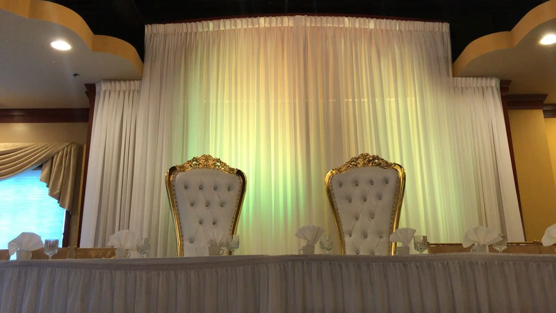 Two white chairs are sitting in front of a table.