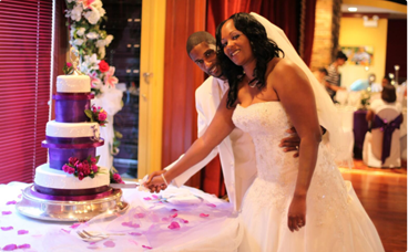 A bride and groom cutting their wedding cake.