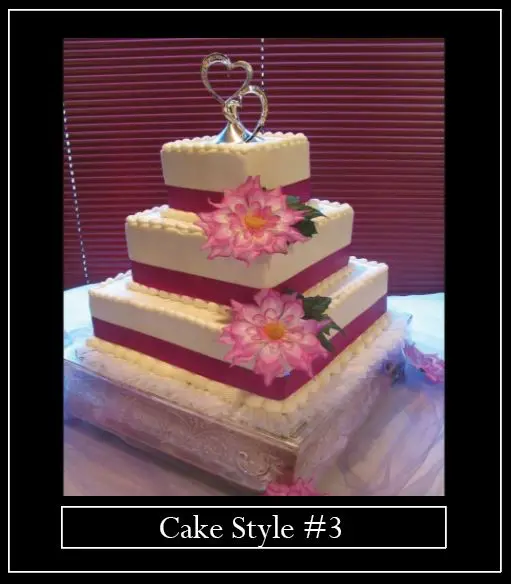 A three layer cake with pink flowers on top.